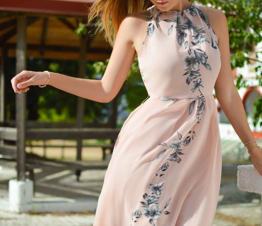 woman wearing pink, black, and white floral halter-top dress