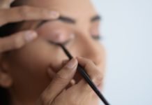 person holding black pen in close up photography