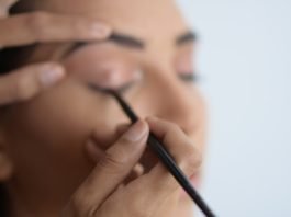 person holding black pen in close up photography